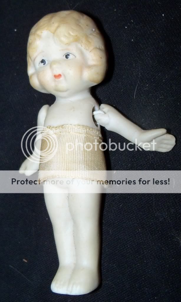 this doll has been broken and neatly repaired there is a crack beneath 